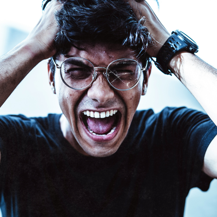 A man holding his hair in frustration