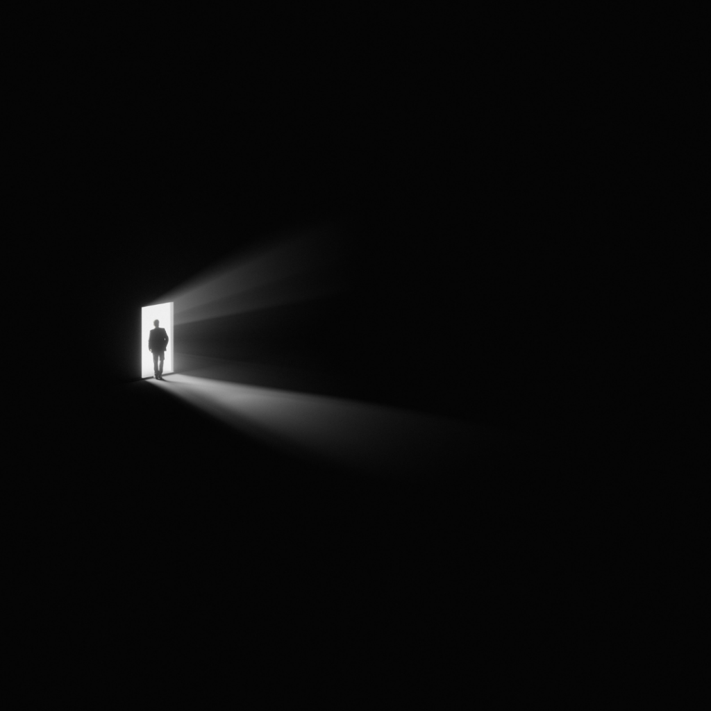 Escape to the light. Figure standing in the door opening, viewed from a dark room.