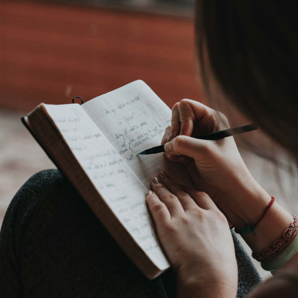 A person writing a list of goals. An important part of investing is knowing what you're doing it for.