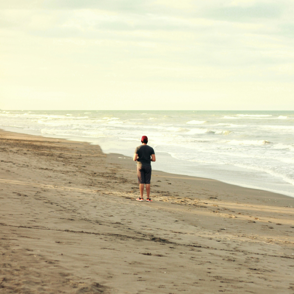 Man standing on a beach.