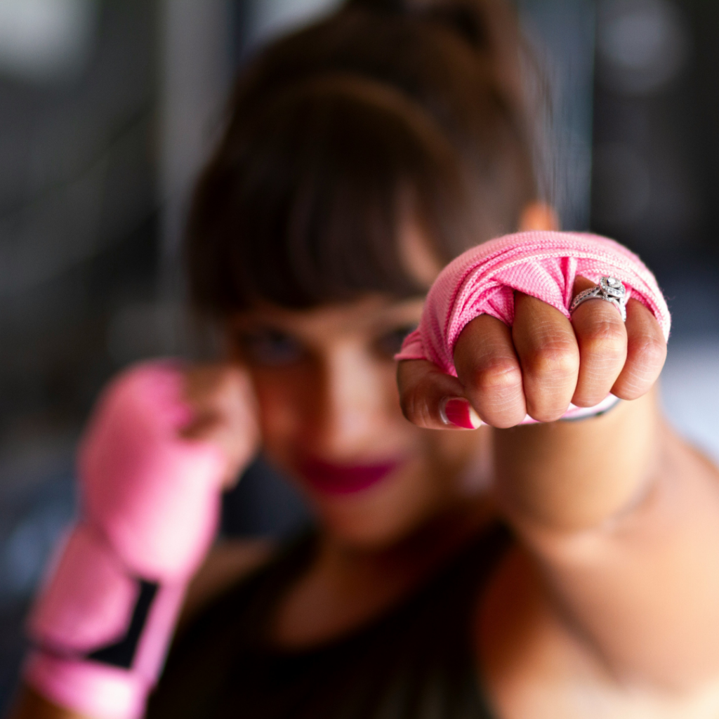 Woman punches to the camera.