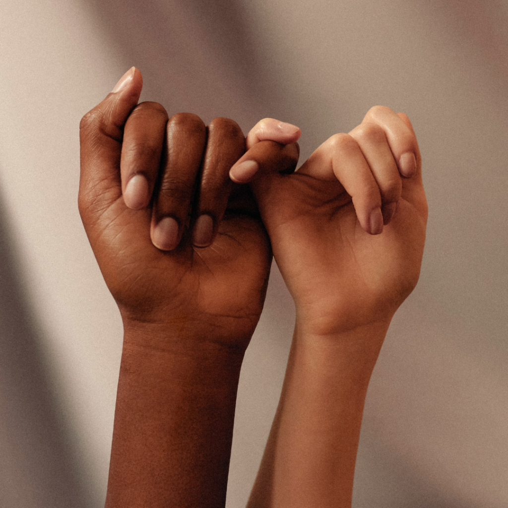 Two people giving a pinky promise.