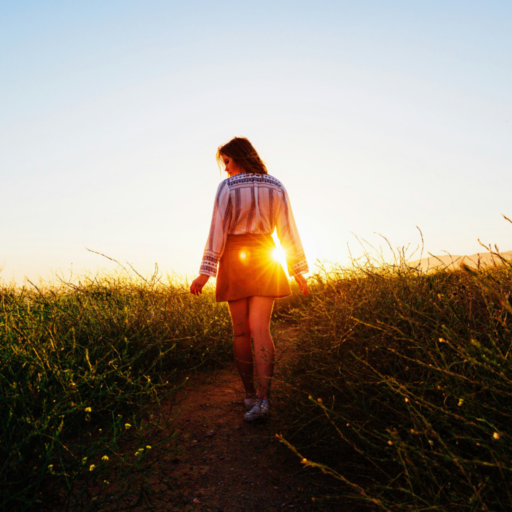 Woman walking in a field.