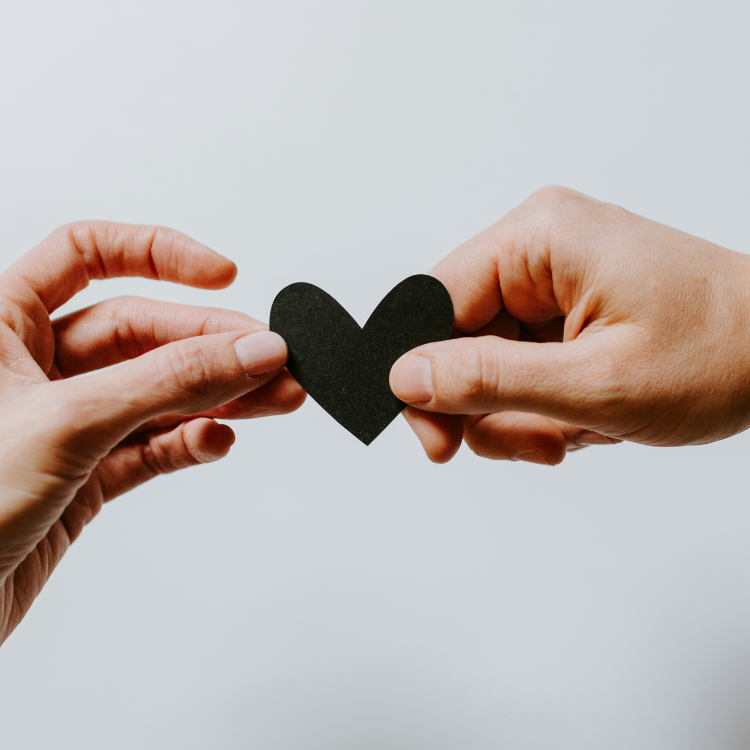Two people sharing a heart.
