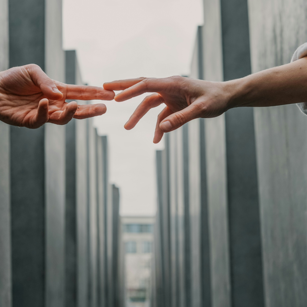 Two hands touching as social beings