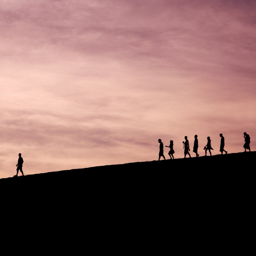 A group of people following someone.