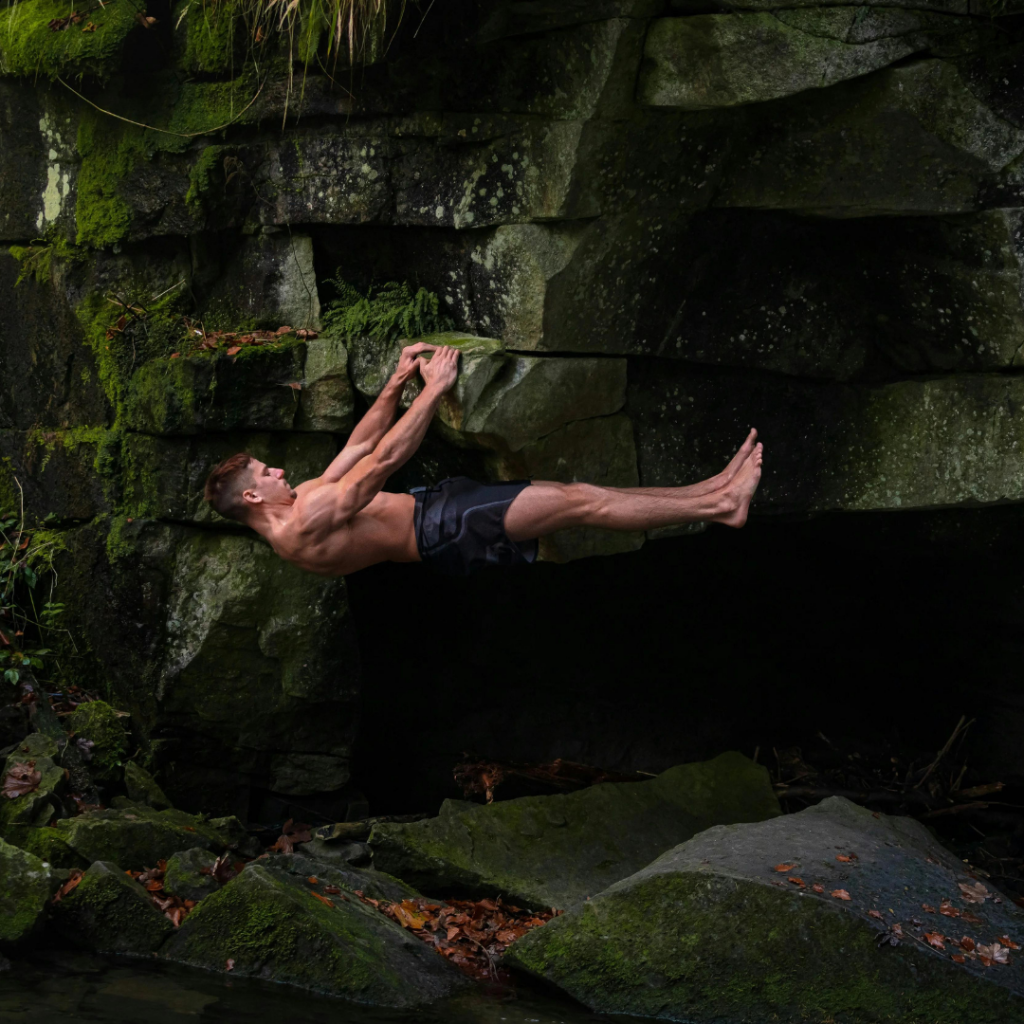 A man rock climbing to show strength and agility.